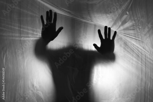 Male silhouette behind plastic curtain. Addiction way out concept photo