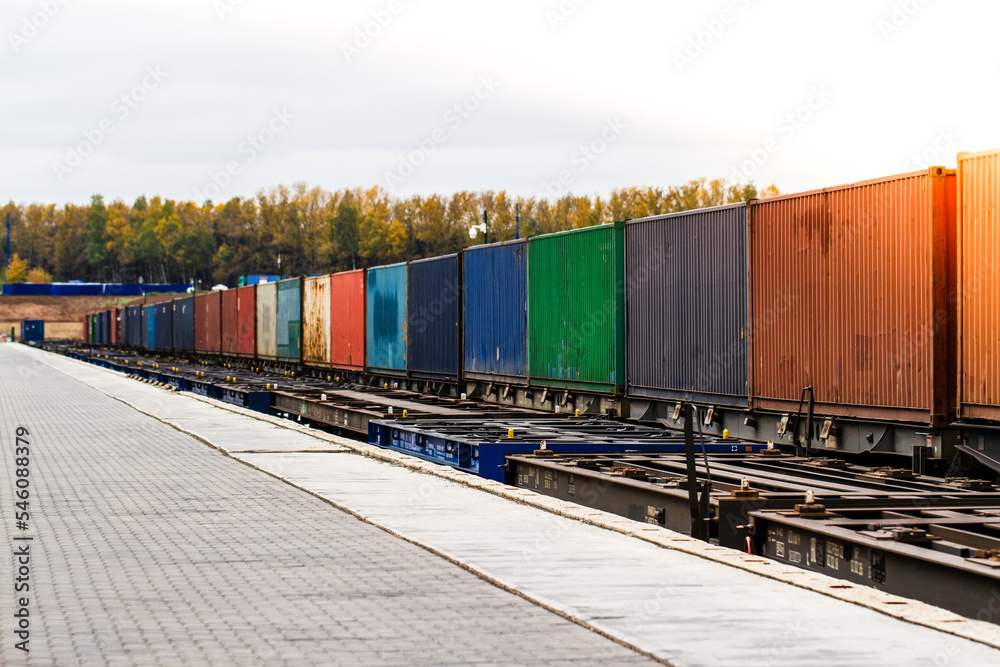 Freight train. Cargo containers transportation by railway. Impoert export logistics concept. Shipping by train. Cargo train platform. Freight train. Cargo containers transportation by railway. Impoert export logistics concept. Shipping by train. Cargo train platform.