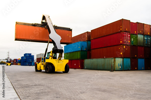 Container handlers. Forklift truck in shipping yard. Industrial container logistic yard. Logistics import export concept.