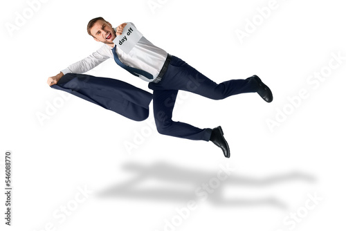 Flying happy businessman holding paper with text DAY OFF on white background