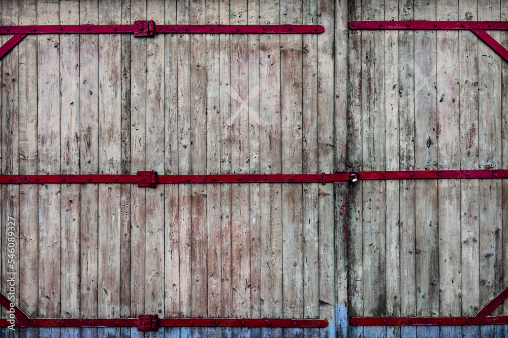 Huge wooden gate with a padlock
