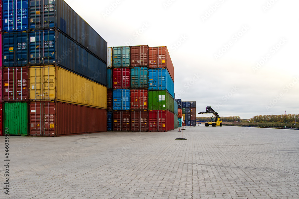 Fototapeta premium Cargo containers. Cargo container yard. Stack of freight containers at the docks. Industrial yard. Import and export logistic concept.