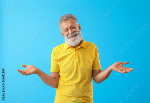Senior bearded man in yello...