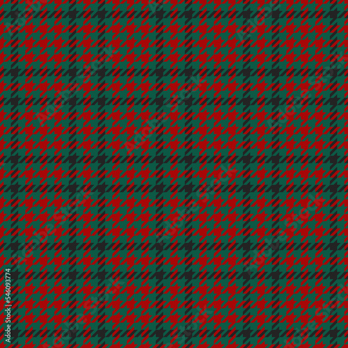 Goose foot. Pattern of crow's feet in black, red, green cage. Glen plaid. Houndstooth tartan tweed. Dogs tooth. Scottish checkered background. Seamless fabric texture. Vector illustration