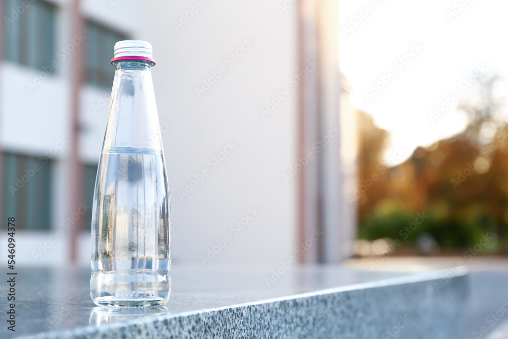 Bottle of water on step outdoors, closeup Bottle of water on step outdoors, closeup