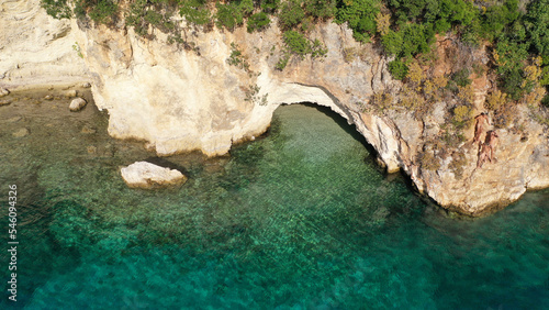 Aerial drone photo of famous small bay and beach with crystal clear sea and caves of Desimi near Nidri in island of Lefkada, Ionian, Greece