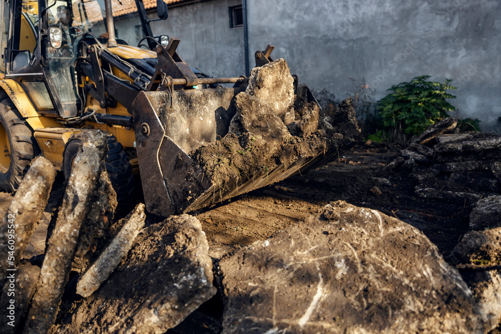 Selective focus on excavator part digging asphalt on construction site. Selective focus on excavator part digging asphalt on construction site.