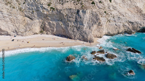 Aerial drone top down photo of tropical exotic paradise secluded rocky bay with deep turquoise sea forming a blue lagoon