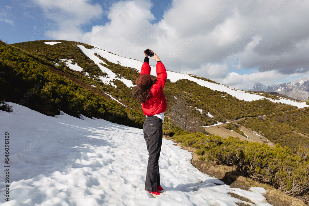 Obraz premium the girl with the red jacket and snow