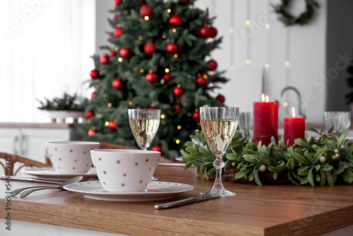 Christmas table setting with glasses of champagne in kitchen, closeup