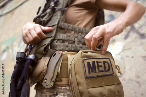 A soldier, a tactical medic opens a first aid kit, close-up view.