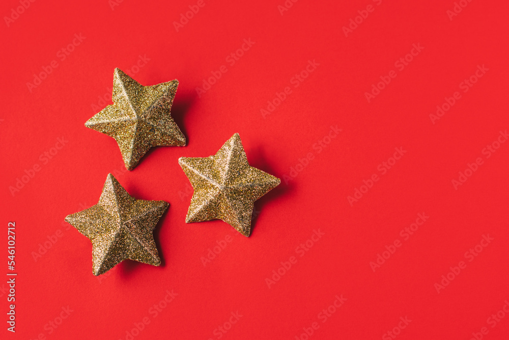 Golden sparkling stars on a red background. Golden sparkling stars on a red background.