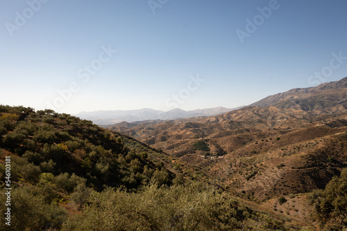A view of spanish mountains taken from the hill above Arenas in Malaga, Andalusia. These rocky looking mountains are scattered with holiday homes and farms for crops like figs and olives