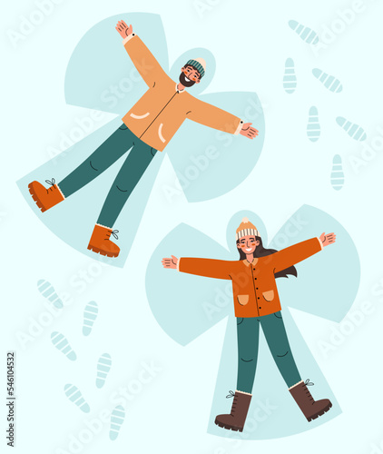 Young couple lying in snow on back and moving arms and legs. Smiling man and woman making snow angels. Winter entertainments concept. photo