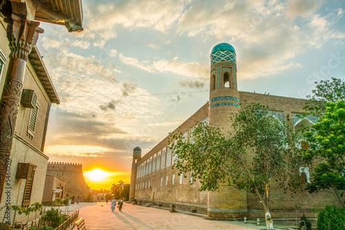 Sunset in old   town of   old Khiva   and blue-green heads of Minarets in Khiva photo