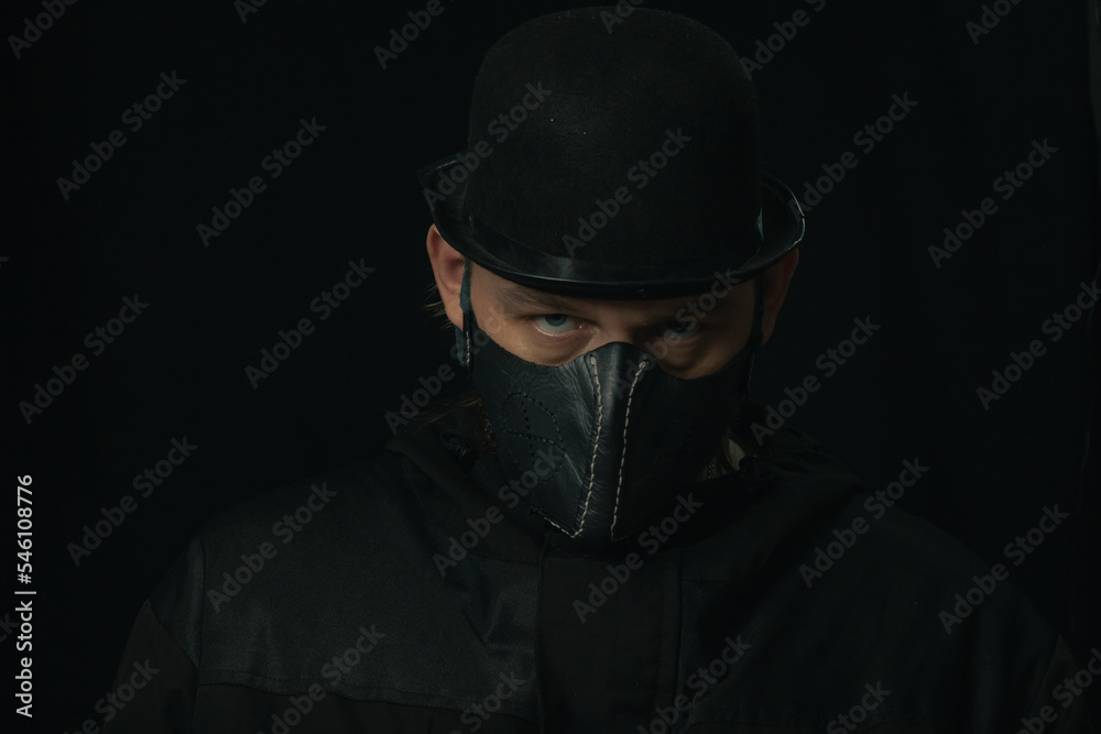 Scary figure with creepy mask and hat in the dark