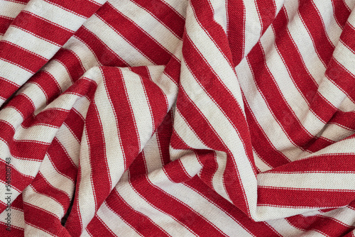Textile texture, abstract background. Red - white striped color, smooth wavy lines