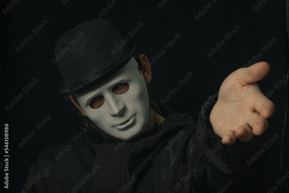 Scary figure with creepy mask and hat in the dark Scary figure with creepy mask and hat in the dark