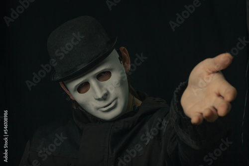 Scary figure with creepy mask and hat in the dark
