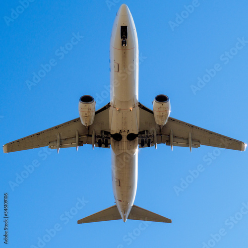 zenithal shot under a commercial aircraft landing, with landing gear removed