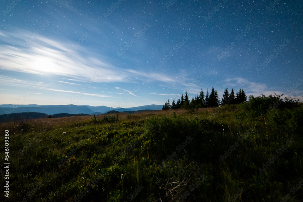 Night view of High Tatras from Panska Hola, Low Tatras National Park Slovakia.Green meadows and mountains in the background. Night view of High Tatras from Panska Hola, Low Tatras National Park Slovakia.Green meadows and mountains in the background.