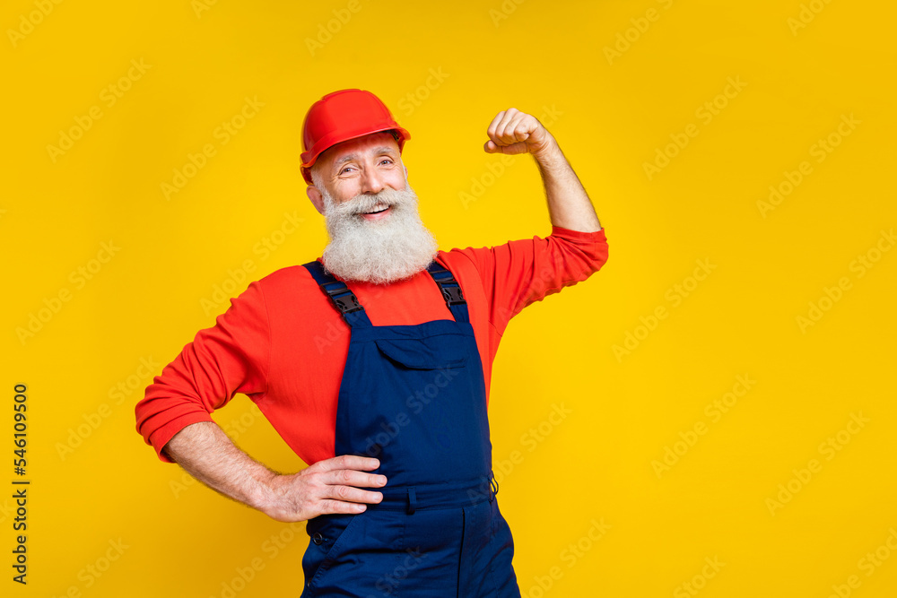 Photo of confident retired senior construction worker show triceps repair buildings isolated shine color background