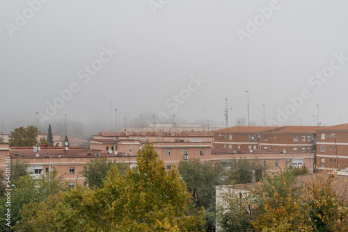 Cityscape against sky in the fog