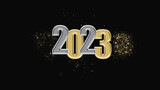 Golden and silver color number 2023 New Year and glitter isolated on black background.