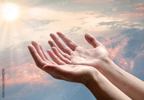 The outstretched hands of a praying man