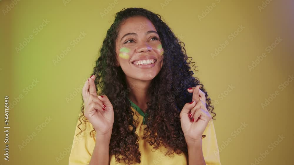 Black woman, soccer fan from Brazil, cheering, desiring, wanting a lot.