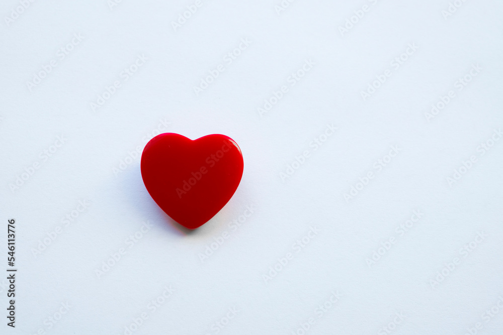 A shiny red heart isolated on a plain background.