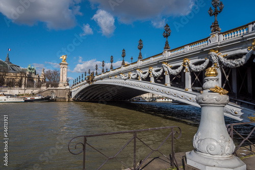 The Pont Alexandre III in Paris France as seen from the banks of the Seine River. photo