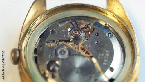 Mechanism of an old mechanical wrist watch chronometer in motion close-up. Pendulum balance wheel and running of life. Tiime flow  photo