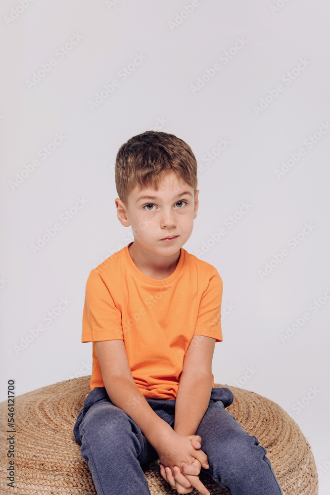 Emotional portrait of 5 boy wearing orange t-shirt. Emotional portrait of 5 boy wearing orange t-shirt.