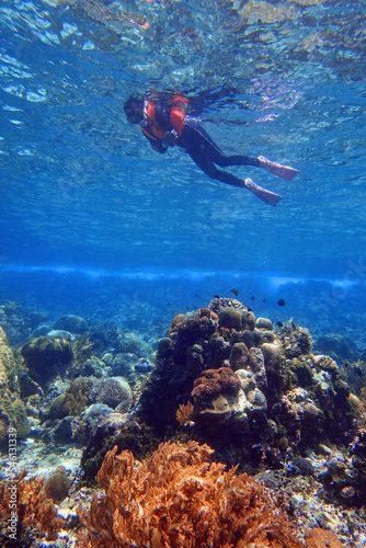 Indonesia Alor Island - Marine life Woman snorkeling in coral reef