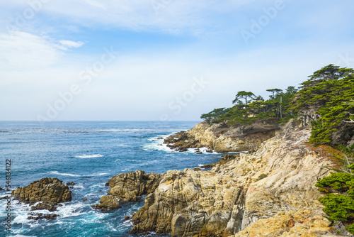 Monterey Bay, California. Rocky coastline, cypress trees, Pacific Ocean, and beautiful cloudy sky