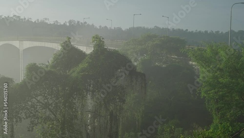 Green Rain Forest Foggy Misty Morning Sunrise with Tukad Bangkung Bridge Pelaga The highest bridge in Asia on the Background photo