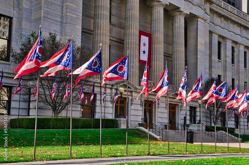 state of Ohio flags aligned with the Ohio statehouse / Capital in downtown Columbus Ohio.   Traditional 2 star Service Flag hanging from the statehouse.  photo