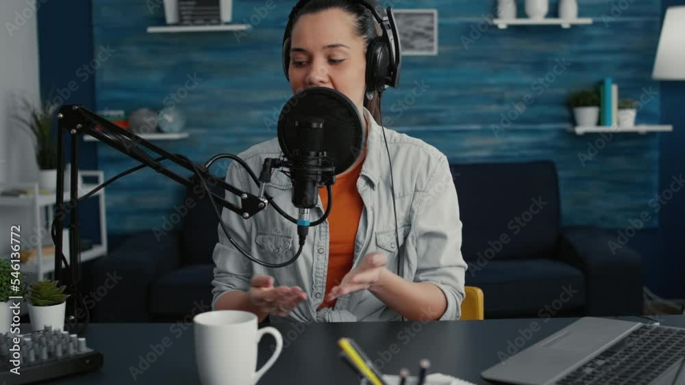 Happy smiling popular internet show host ending live broadcast while sending air kisses to audience. Social media star saying goodbye to public while sitting at home studio desk.
