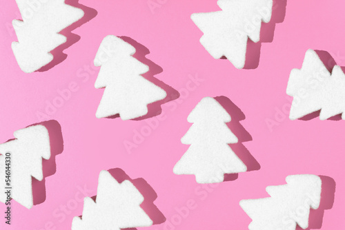 White Christmas tree decoration with pink background. Minimal New Year holiday concept. Flat lay.
