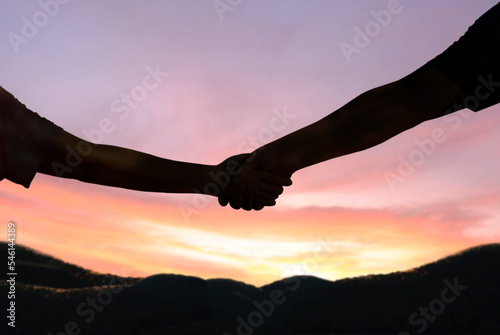 Silhouette handshake hope peace freedom nature morning sun concept of help and hope
