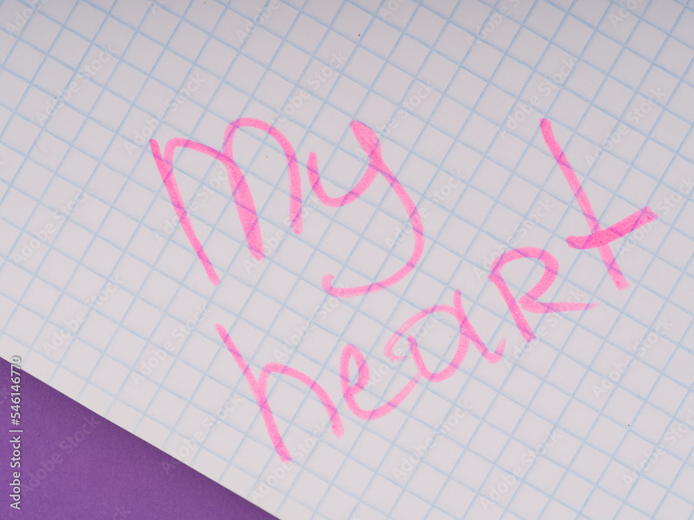 The concept of warm feelings. The inscription on the notebook sheet with a pink marker my heart