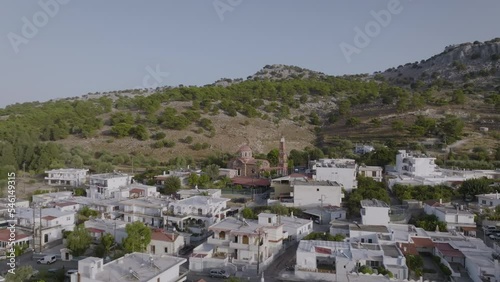 Aerial over Pilonas village in Rhodes, Greece - view of Greek Orthodox church photo