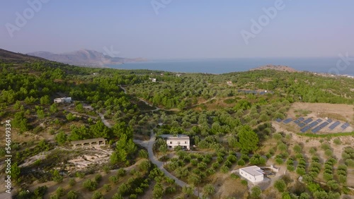 Aerial pullback riser over vast olive groves close to coastline, Pilonas, Rhodes photo