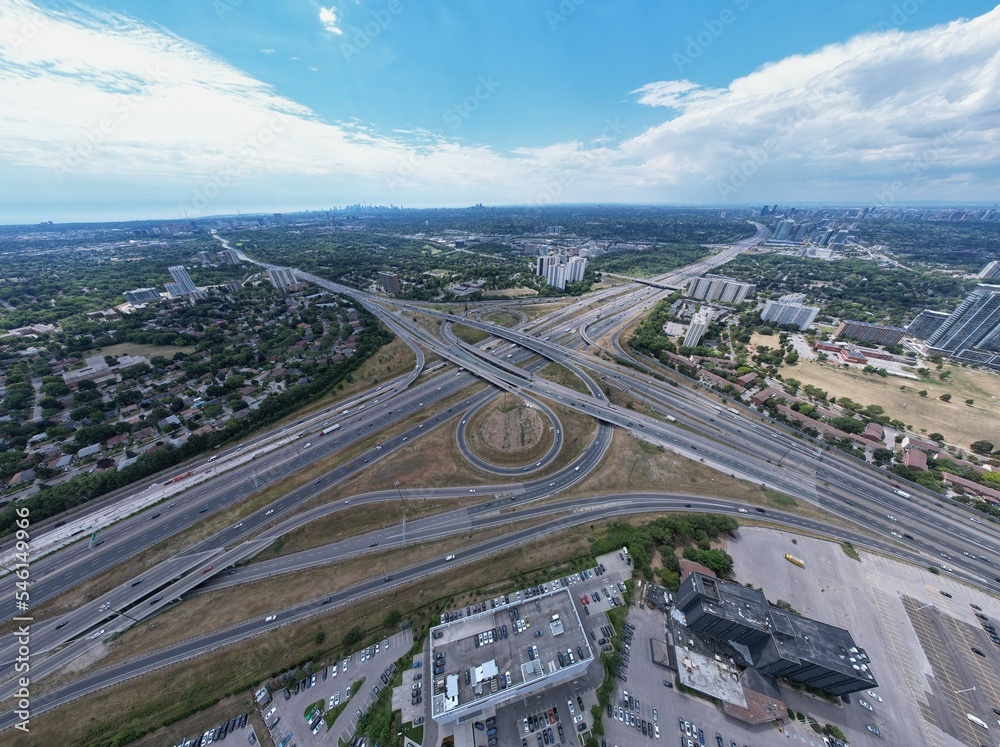 Highway for high speed commute and road traffic avoidance. Cars transportation junction development. Expressway in Canada view from above. Exit or entrance road lanes with speed ramps.