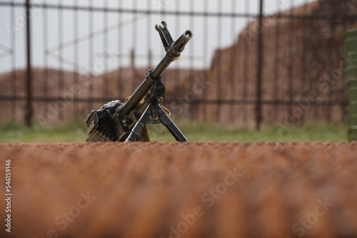 Almaty, Kazakhstan - 04.14.2022 : A Kalashnikov assault rifle is mounted against the background of a number of ammunition.