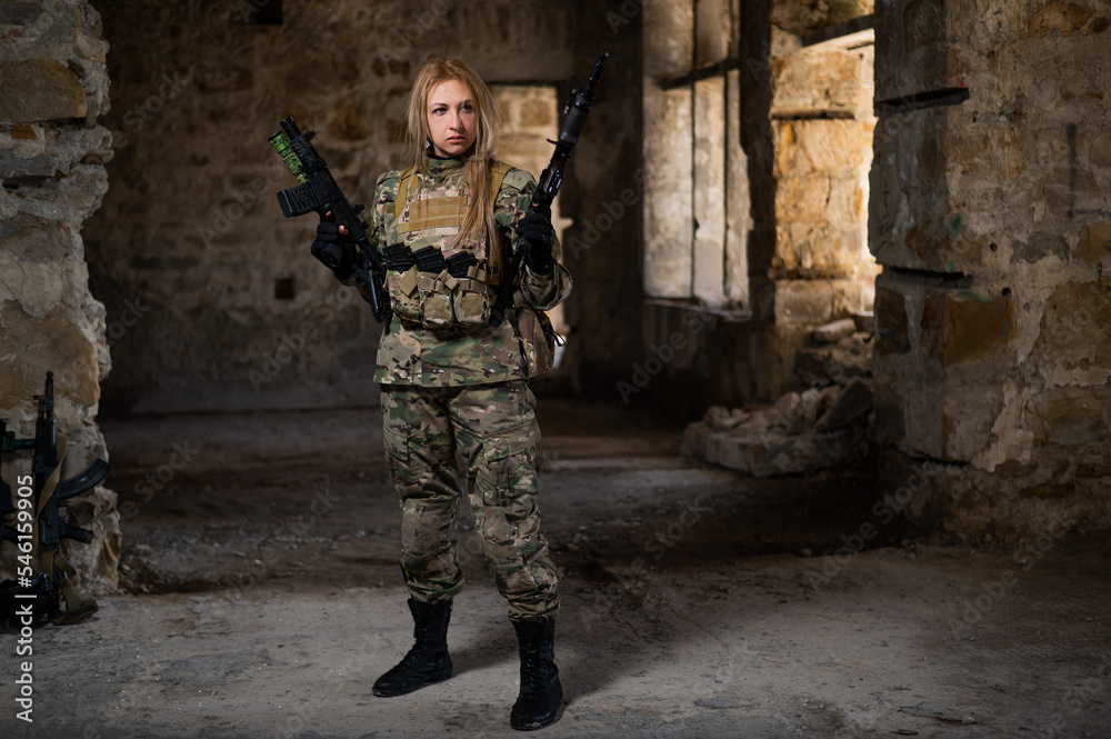 Blonde woman in army uniform holding a firearm in an abandoned building. 
