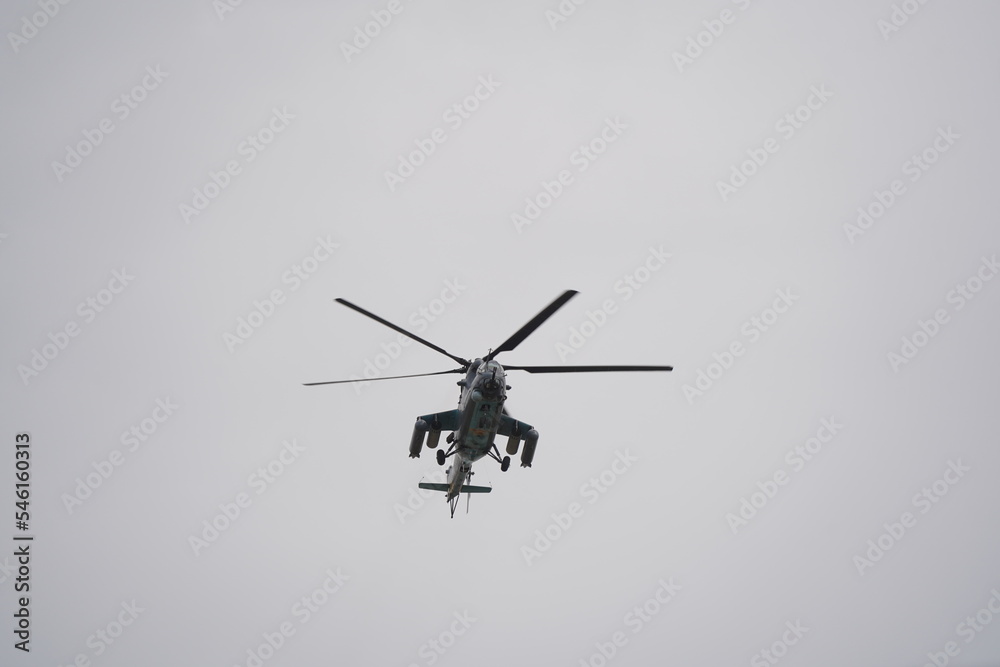Almaty, Kazakhstan - 04.14.2022 : A military helicopter flies over the training ground during an exercise. Almaty, Kazakhstan - 04.14.2022 : A military helicopter flies over the training ground during an exercise.