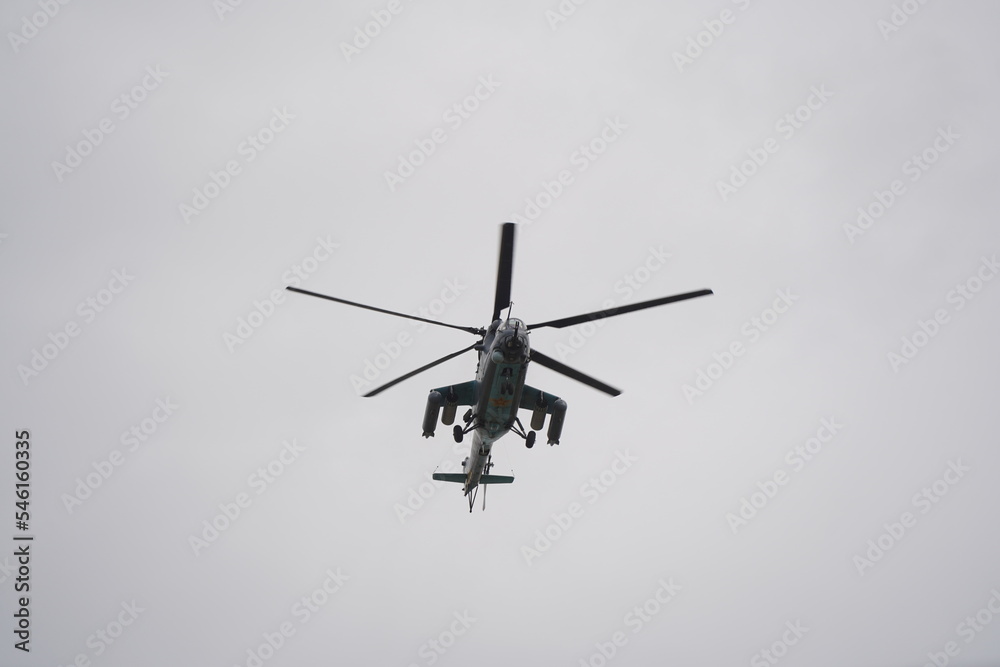 Almaty, Kazakhstan - 04.14.2022 : A military helicopter flies over the training ground during an exercise. Almaty, Kazakhstan - 04.14.2022 : A military helicopter flies over the training ground during an exercise.