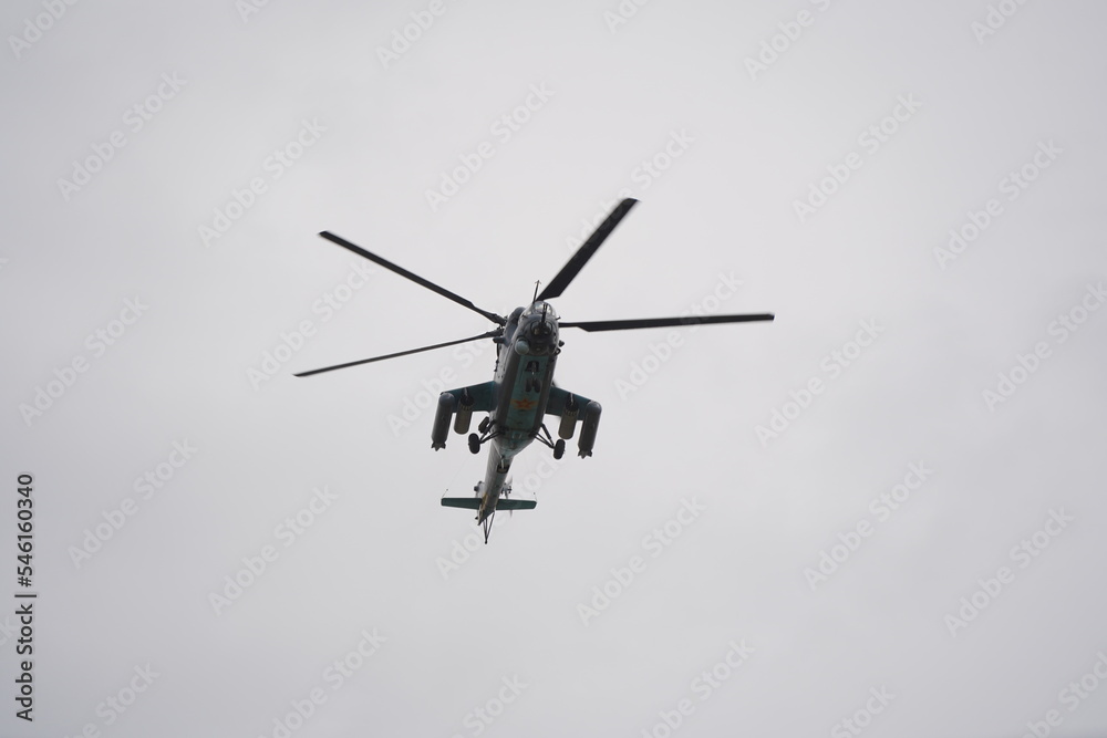 Fototapeta premium Almaty, Kazakhstan - 04.14.2022 : A military helicopter flies over the training ground during an exercise.